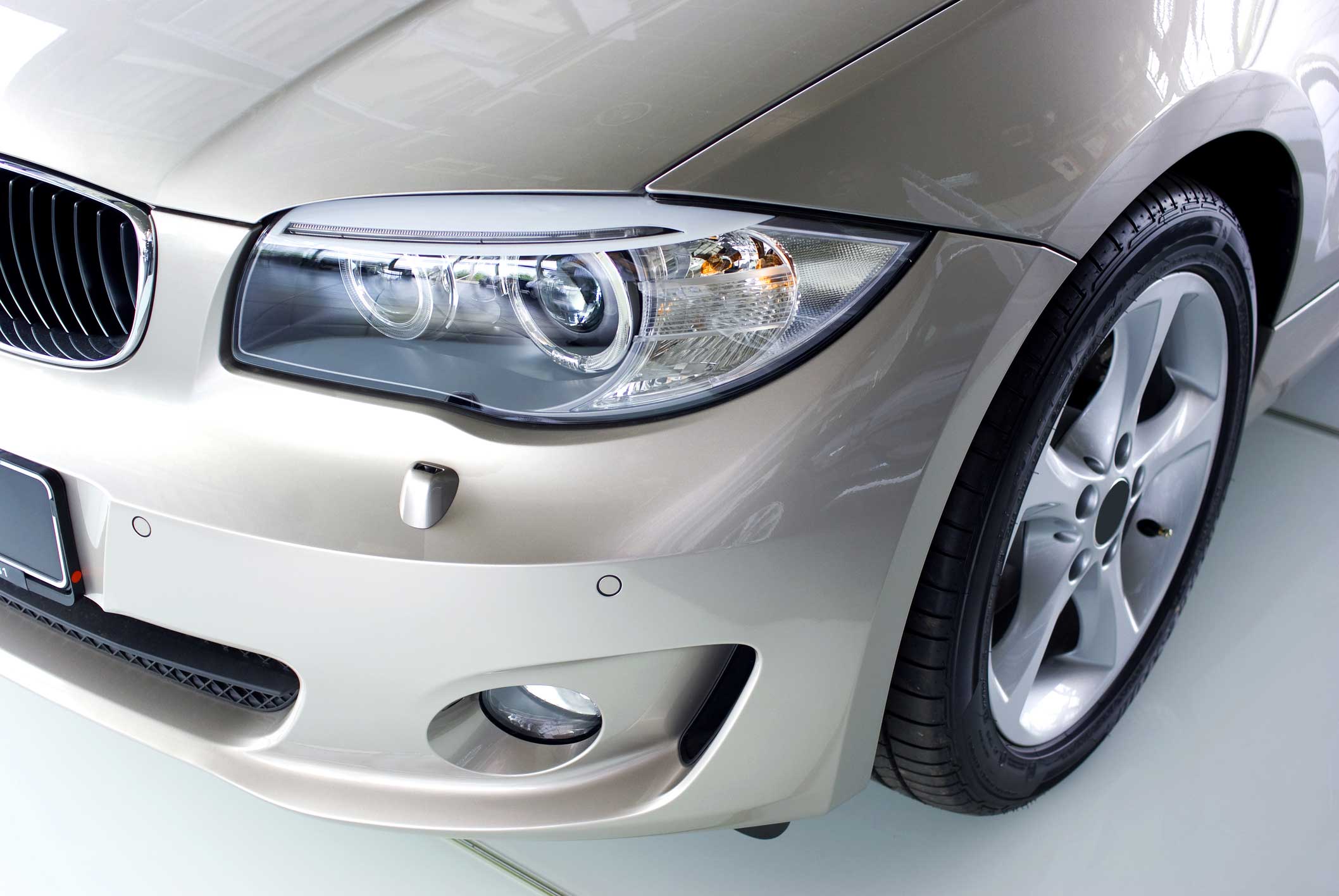 New car in showroom, focus on xenon headlights